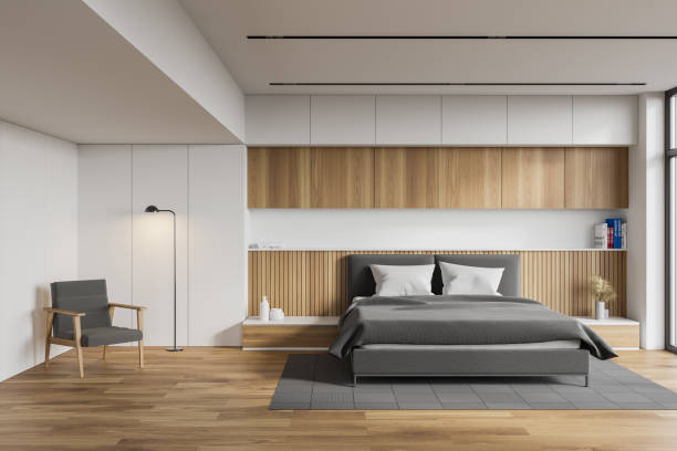 istock White and wooden master bedroom with armchair 1249772704