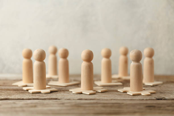 istock Wooden figures on puzzles. People analytics and optimization, team building. Group connection in business 1249772728