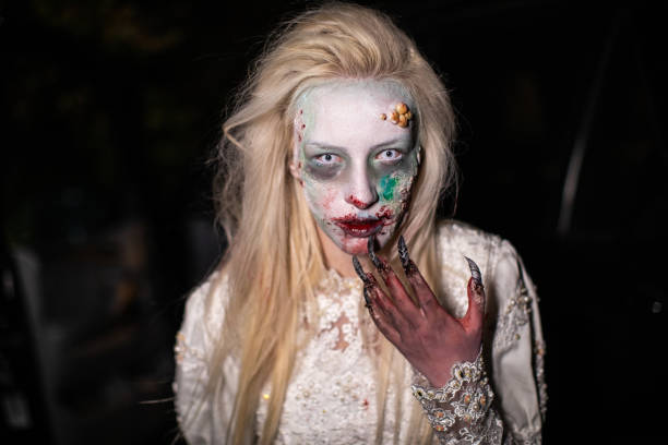 istock Female vampire with bloody lips after biting victim 1249775567
