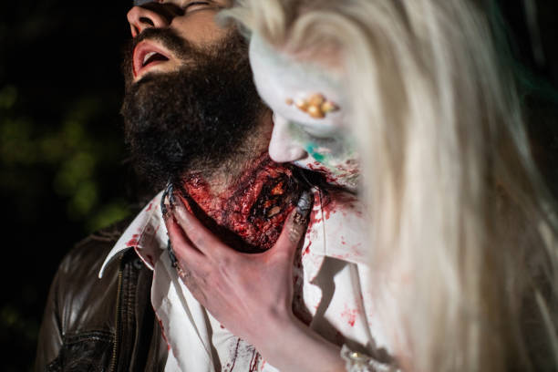 Zombie biting young man's neck in forest at night Female zombie with white hair biting young man's neck in forest at night male vampire biting his victim stock pictures, royalty-free photos & images