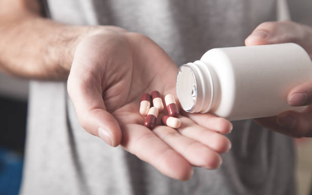 istock Close up of a man holding a pills. 1249775922