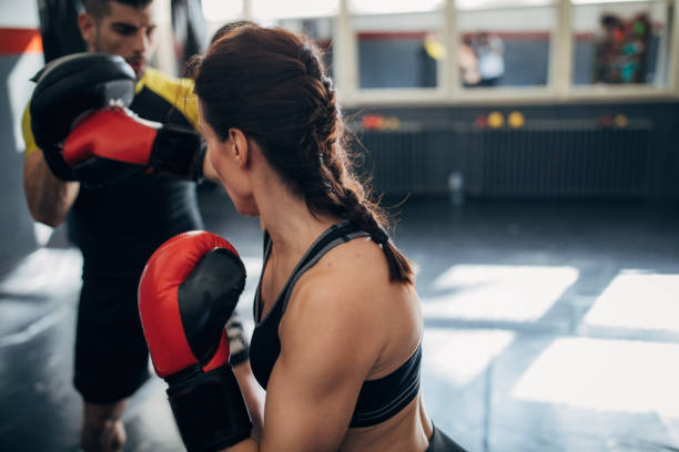 istock One woman kickboxer sparring with her coach 1249779365