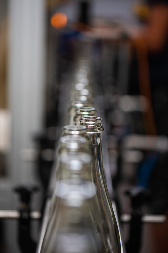 clear champagne bottles on a bottling line