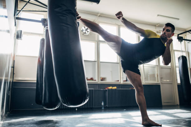 istock One kickboxer kicking a punching bag 1249779590