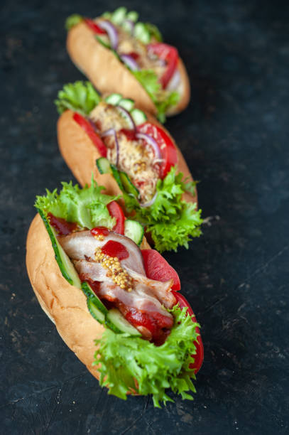 istock Hot dogs with different fillings. View from above. Against a dark background. Flat lay. 1249779627