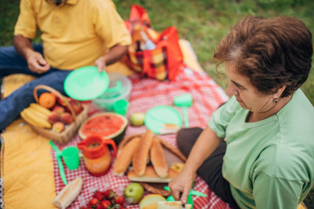 istock An elderly couple picnic on the grass 1249781147