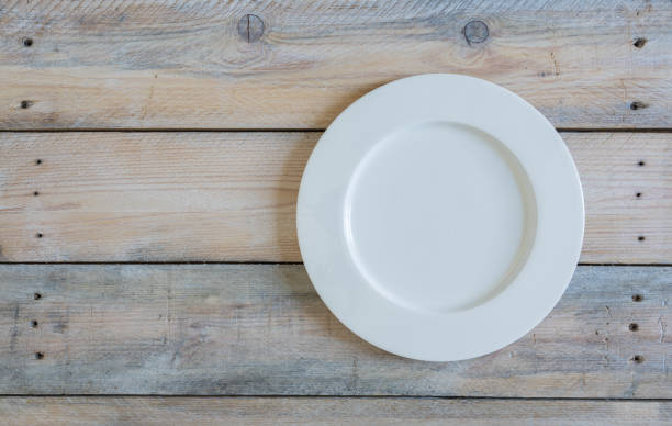 istock Empty plate on used look wooden background 1249785062