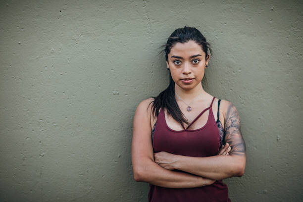 istock Beautiful fit lady standing against the wall 1249785661