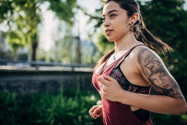istock Woman jogging in city park 1249787624