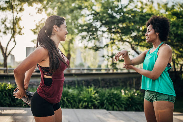istock Two ladies exercising in city park together 1249788652