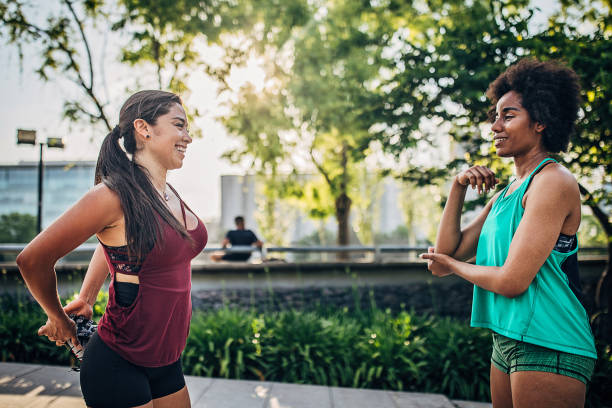istock Two ladies exercising in city park together 1249788689