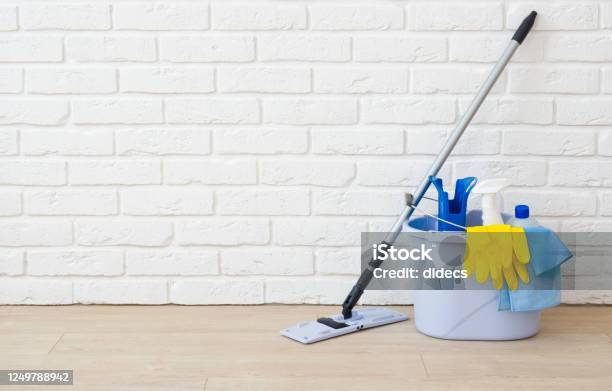 Cleaning Items On Laminated Floor In Empty Brick Wall Room Stock Photo - Download Image Now