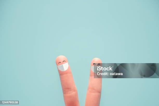 Happy Fingers Wearing Protective Mask And Social Distancing Adapting To New Life Or Business Postlockdown After Coronavirus Pandemic Stock Photo - Download Image Now