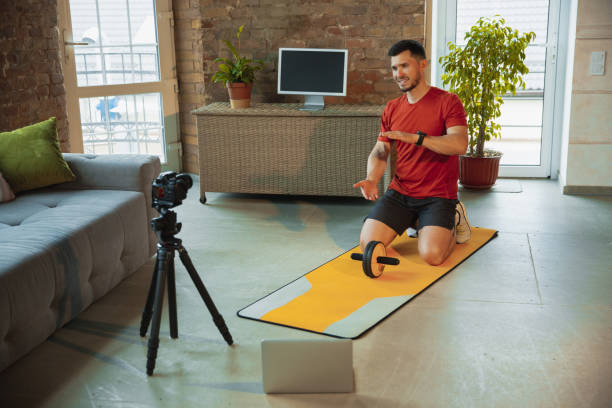 istock Young caucasian man training at home during quarantine of coronavirus outbreak, doing exercises of fitness, aerobic. Staying sportive during insulation. 1249790591