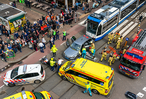 Birds-eye view of emergency services, police, fire brigade and ambulance at the scene of a traffic accident with a tram and a car