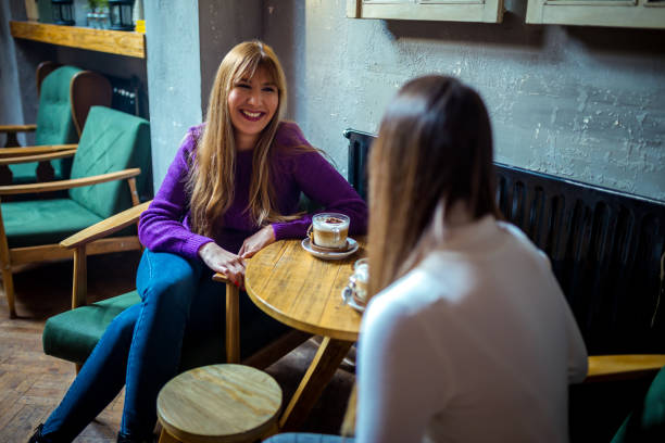istock Female friends enjoying in conversation 1249795741