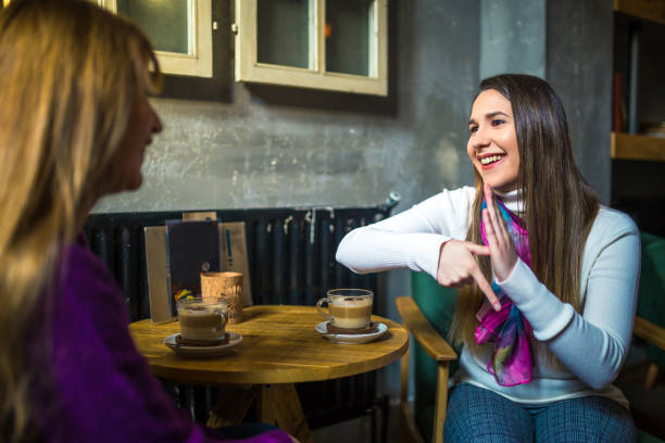 istock Two young woman speak in sign language 1249795911