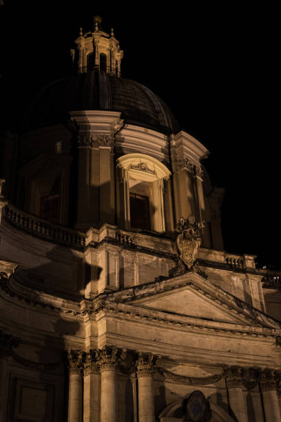 istock Church facade in Piazza Navona at night in Rome 1249796234