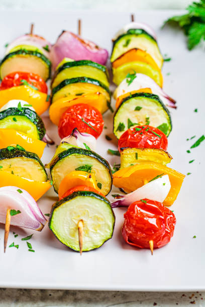 istock Grilled vegetable skewers on gray rectangular plate. Vegan food concept. 1249798866