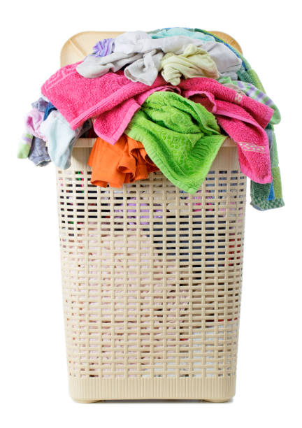 istock Laundry basket full of dirty washing (isolated on white) 1249798903