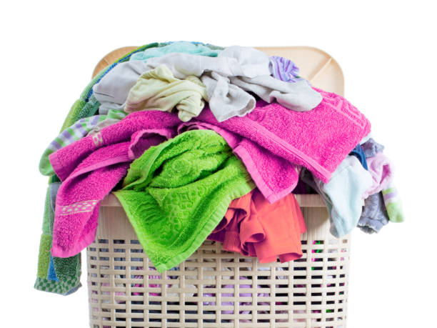 istock Laundry basket full of dirty washing (isolated on white) 1249798925