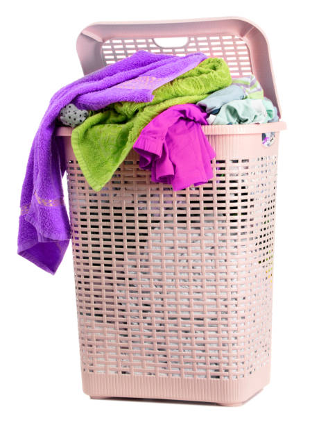 istock Laundry basket full of dirty washing (isolated on white) 1249799091