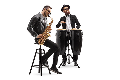 Two male musicians playing a sax and a conga drum isolated on white background
