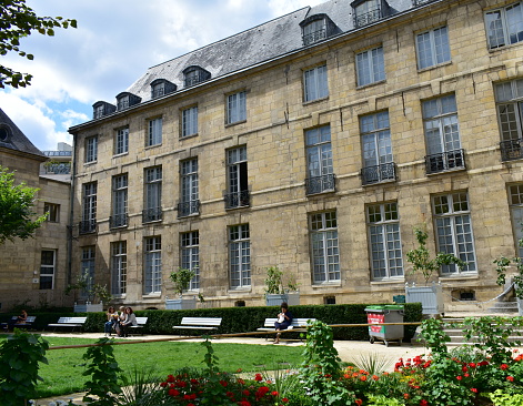 Paris, France. August 14, 2019. Famous hotel particulier style building located at Le Marais. 16th century mansion Hotel de Lamoignon with Hotel-Lamoignon - Mark Ashton garden opened to the public. The best preserved house from this period in Paris.