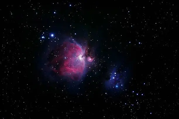 The Great Orion Nebula, also known as M42 (center of the image) and the Runnng Man (right hand). A lot of new stars in an red emissions nebula and blue relection nebula. Image taken with a Canon EOS 20Da camera in prime focus of an professional refractor-telescope at 500mm f/6.7. Exposure time is 85 minutes.
