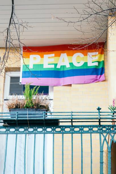 istock Peace rainbow flag on the balcony. Symbol LGBT, text peace 1249801096