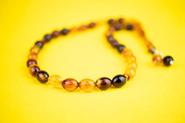 istock Muslim prayer beads on yellow background 1249801320