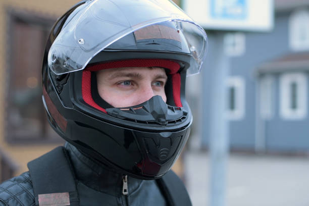 istock Side view of a biker in a helmet with an open visor. 1249801367