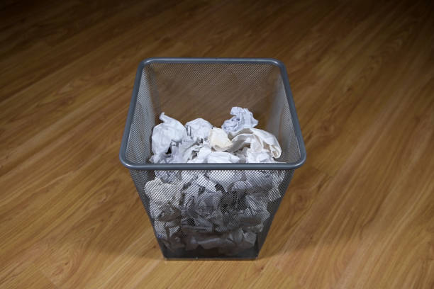 istock A basket of paper trash is on the floor. 1249801426