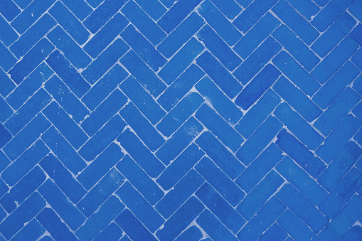 Full frame shot of blue herringbone brick flooring tile texture