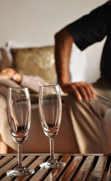 istock Two stemmed glasses on a table in a hotel room 1249804160