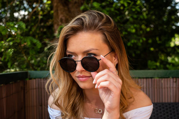 istock Pretty Blond Woman with Sunglasses Looking Away 1249805945