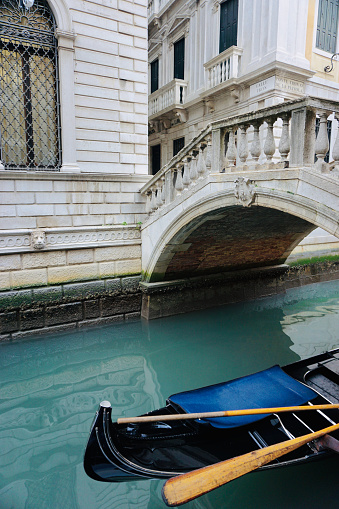 Venice, Italy - October 24, 2022, Gondolier with his gondola near Rialto Bridge
