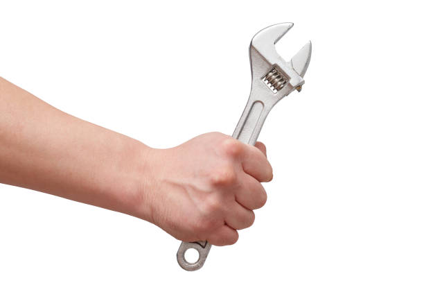 istock the hand holds the wrench. on white background. isolated 1249809243