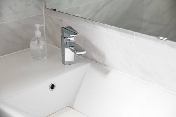 istock closeup faucet in bathroom with alcohol gel 1249809357