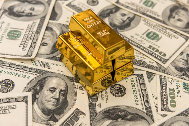 gold bars bullions lying on 100 dollar bills gold bars bullions lying on 100 dollar bills. wealth order gold bars stock pictures, royalty-free photos & images