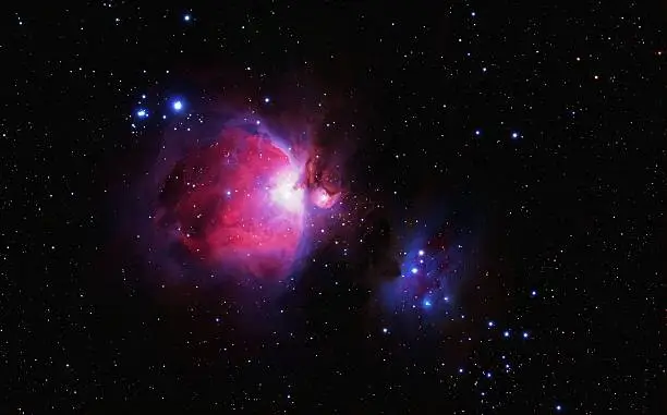 The Great Orion Nebula, also known as M42 (center of the image) and the Runnng Man (right hand). A lot of new stars in an red emissions nebula and blue relection nebula. Image taken with a Canon EOS 20Da camera in prime focus of an professional refractor-telescope at 500mm f/6.7. Exposure time is 85 minutes. This is an reprocessed and color enhanced image, of File Number 1257432, to bring out more details in the outer rim of the nebula.