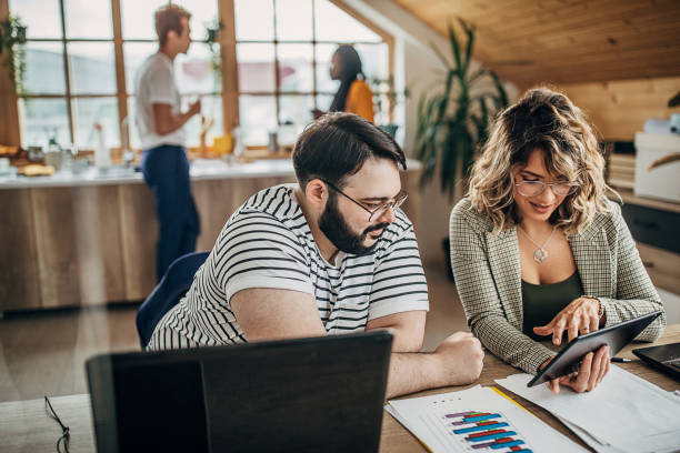 istock Man and woman working together in small modern office 1249811819