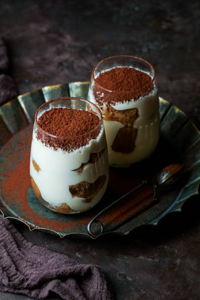 istock tiramisu dessert in glasses on dark concrete background 1249813836