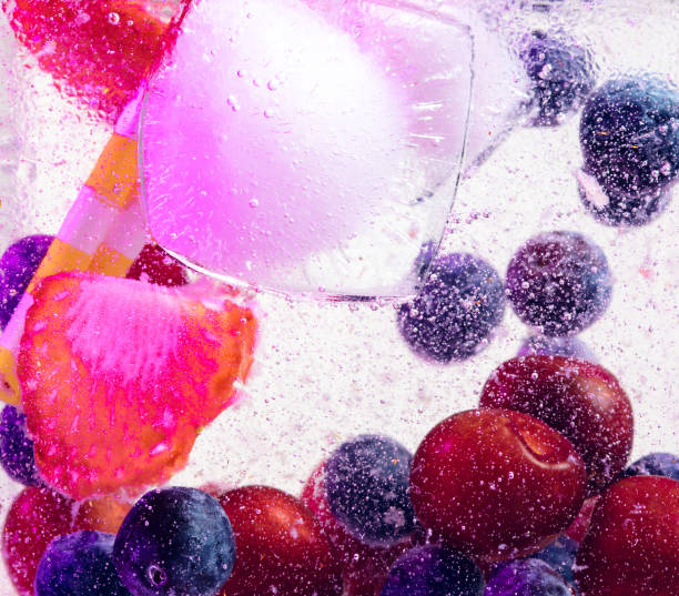 Close up view of the cold and fresh lemonade with bright berries in neon light