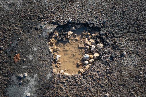 directly above pothole  with brown muddy water