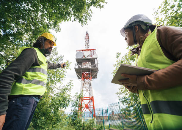 istock Colleagues engineers working on the field near a Telecommunications tower. Teamwork. 1249817810