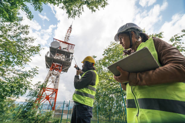 istock Engineers working on the field near a Telecommunications tower. Teamwork. 1249817812
