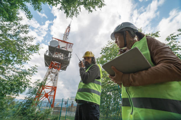 istock Colleagues engineers working on the field near a Telecommunications tower. Teamwork. 1249817817