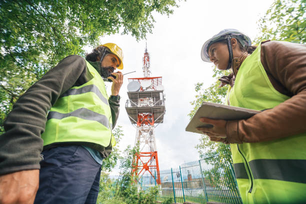 istock Colleagues engineers working on the field near a Telecommunications tower. Teamwork. 1249817835