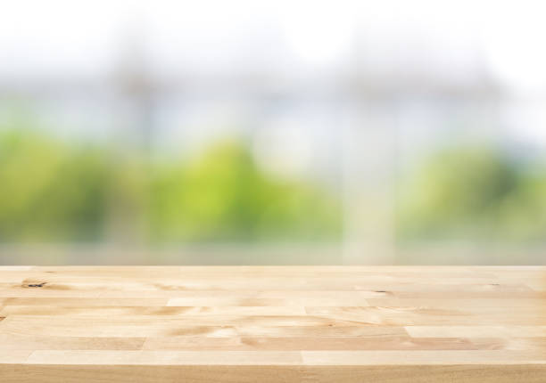 istock Empty wood table top on blur abstract green garden from window kitchen in the morning 1249818337